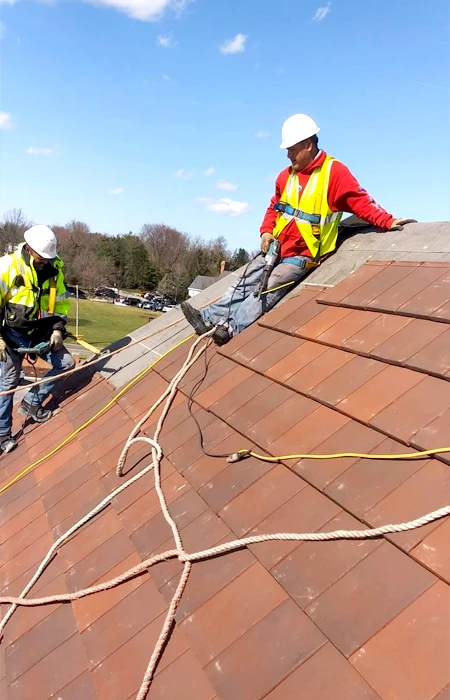 Two men on a roof Installed and designed by America Top Roofing